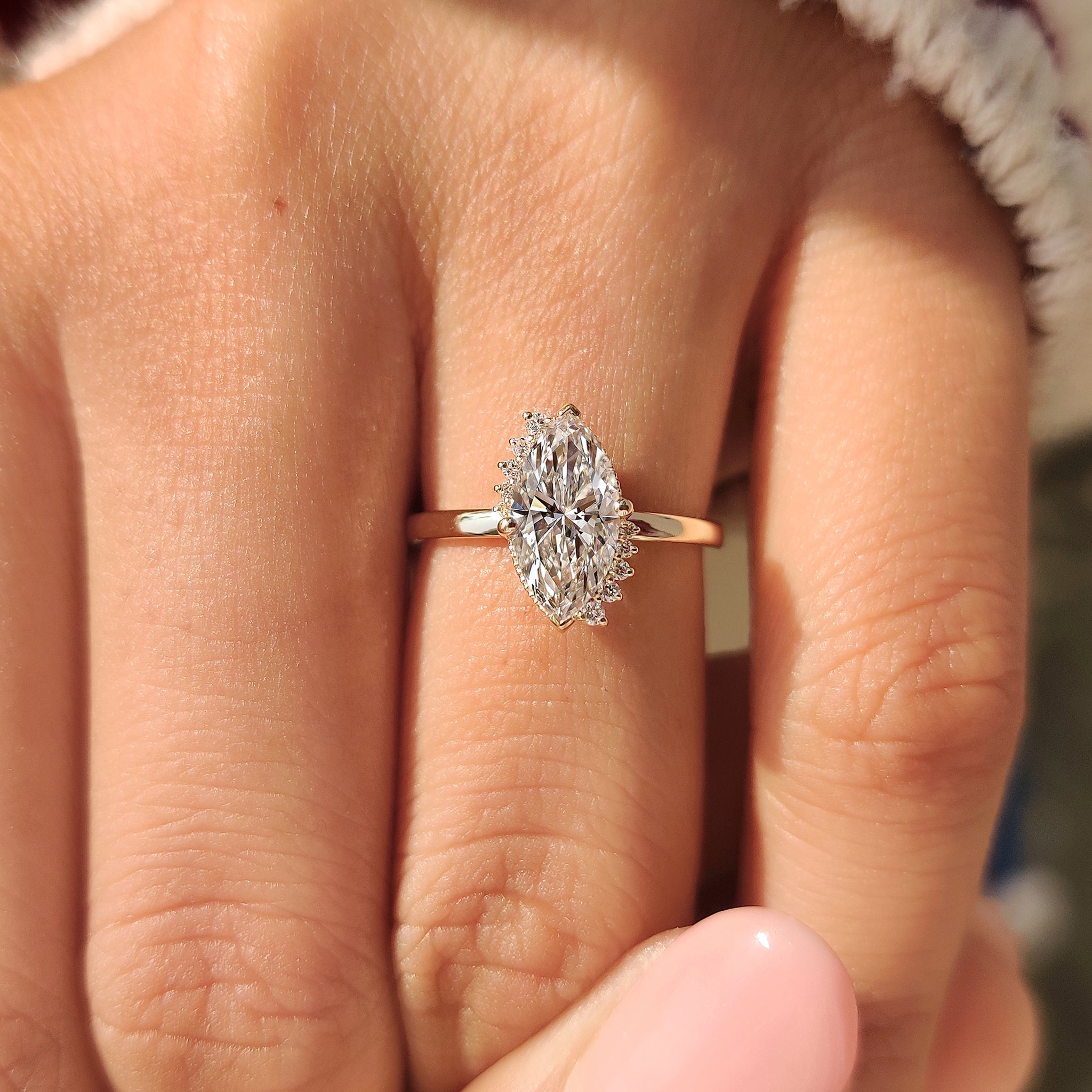 Marquise cut engagement ring with milgrain details.
