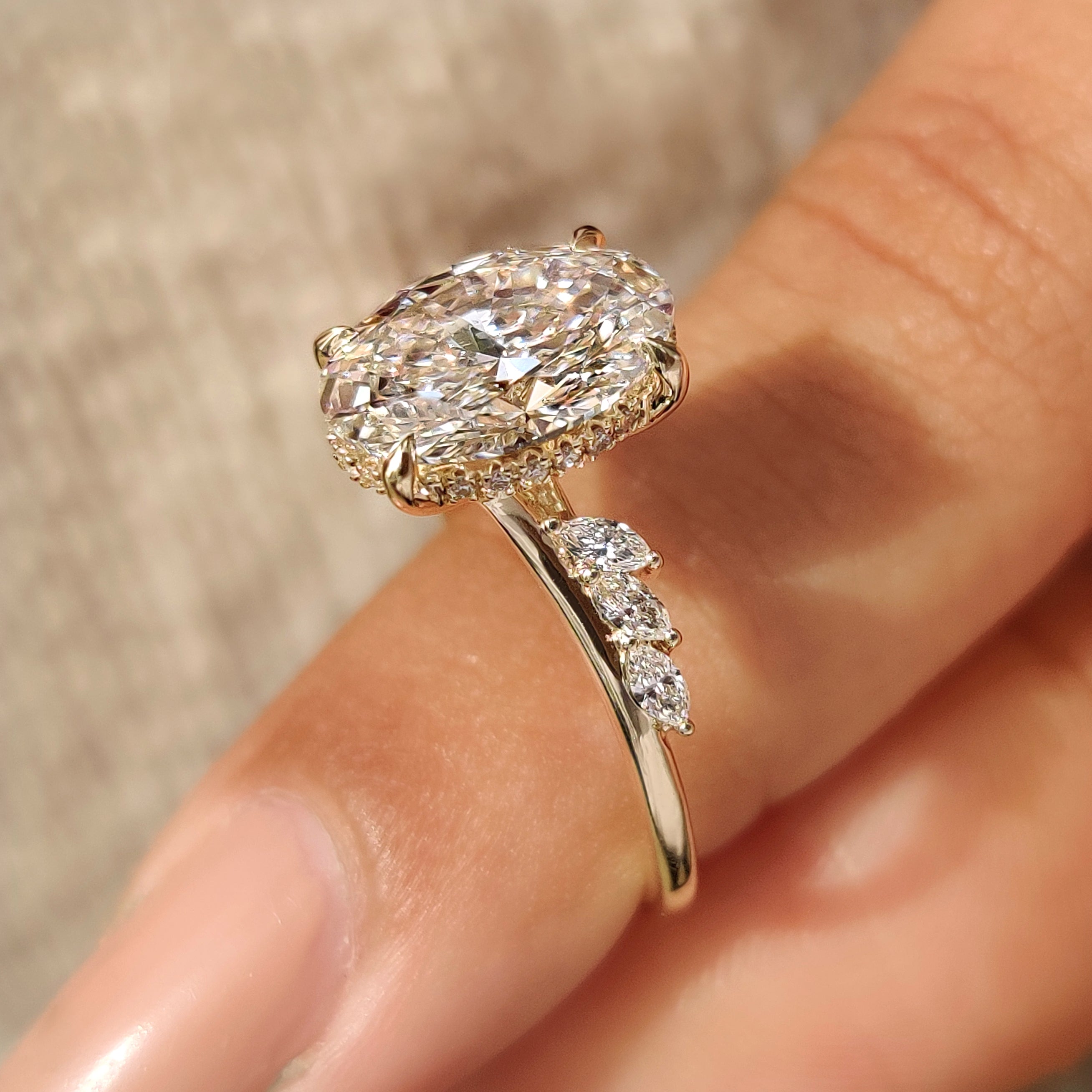 Oval cut center diamond in hidden halo style
