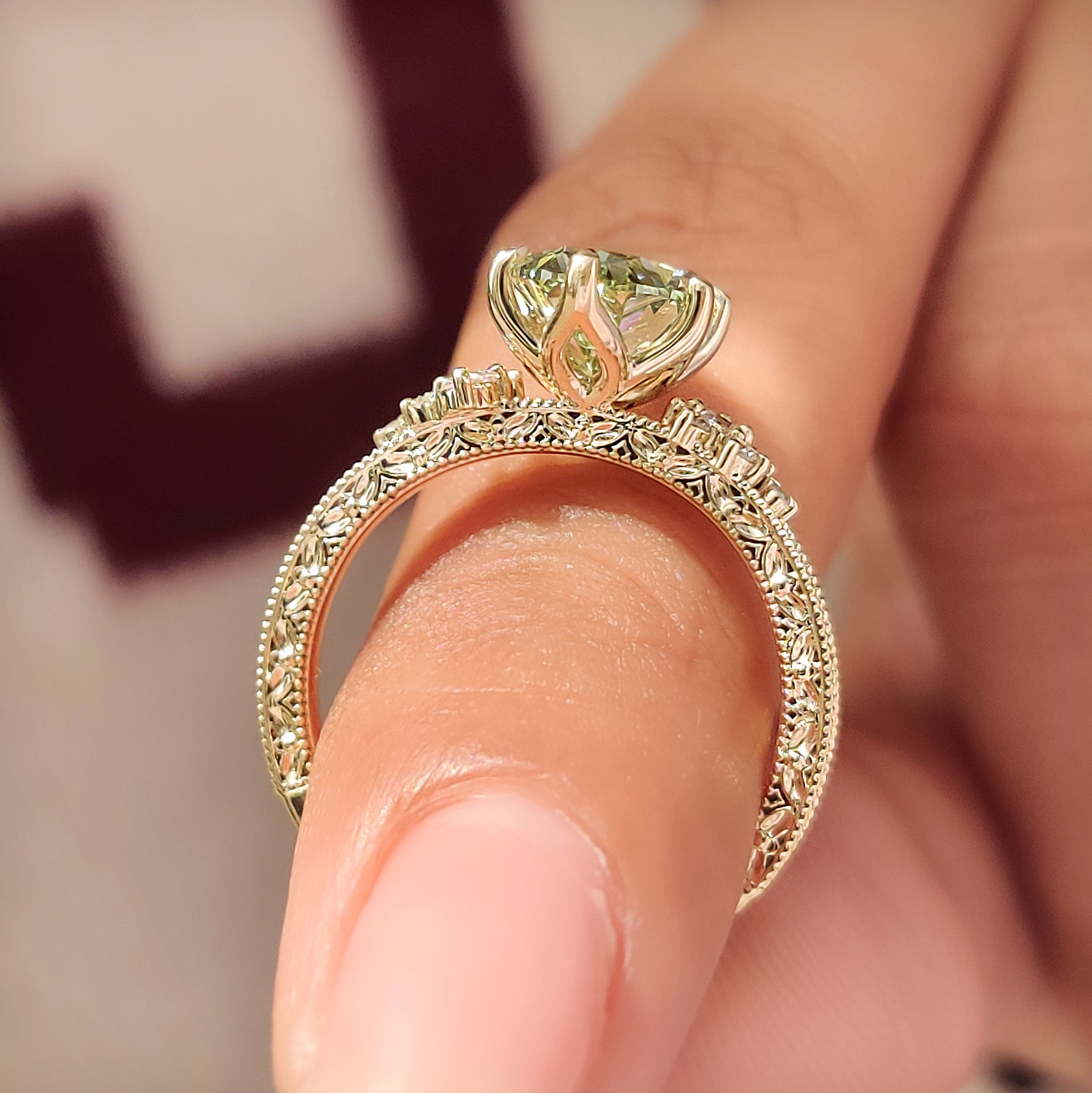 Six claw prong green oval diamond ring
