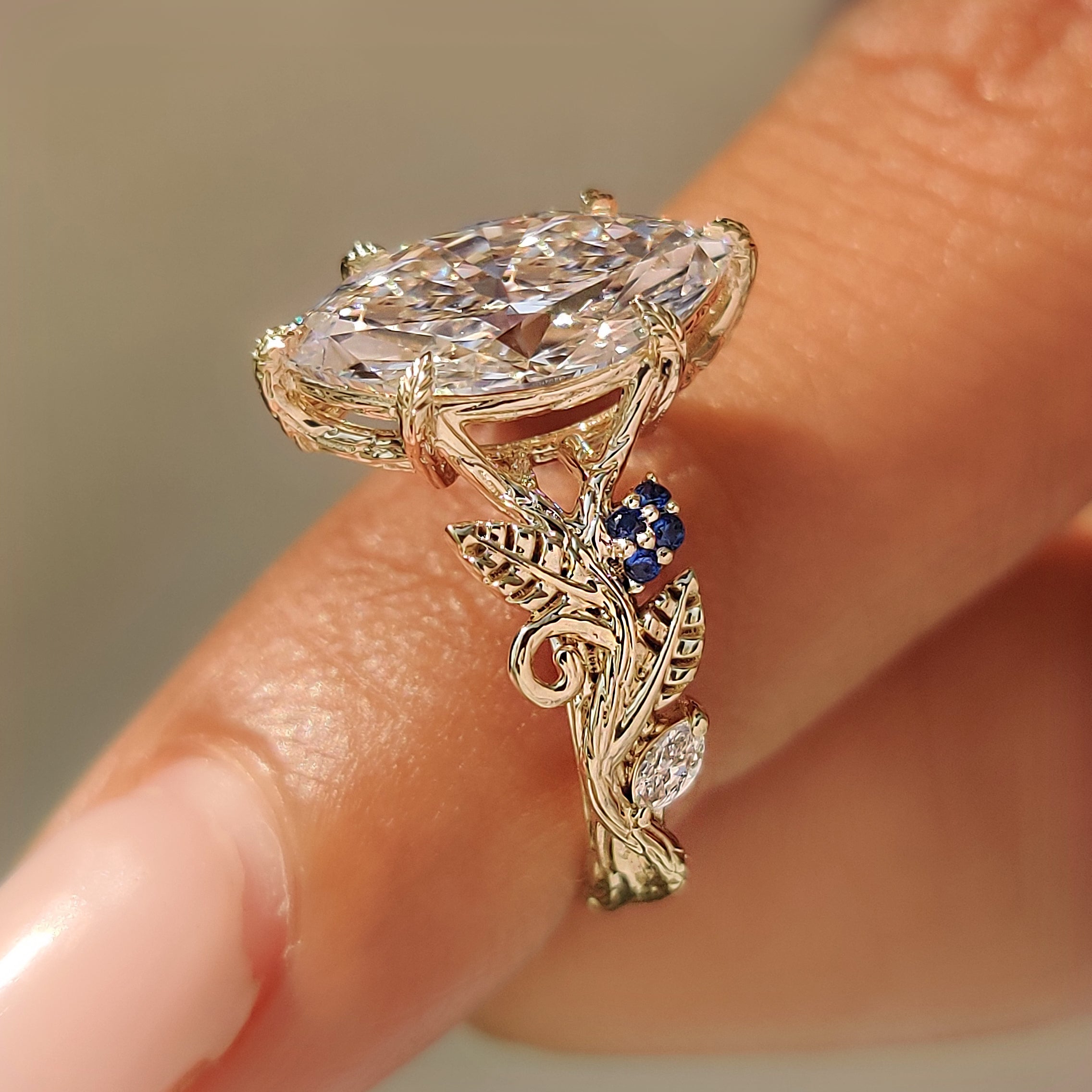 Marquise diamond engagement ring with a split shank design.
