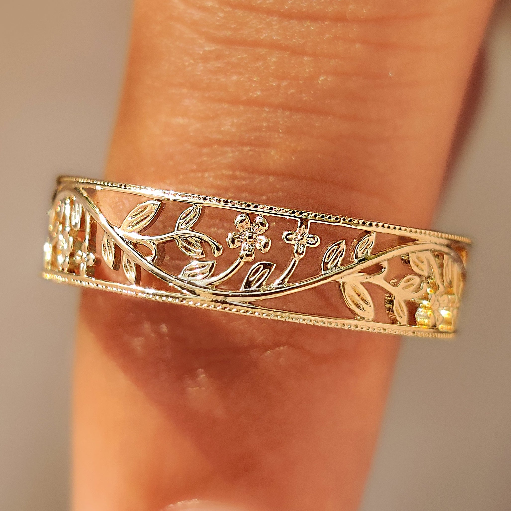 Cherry blossom flower wedding band with openwork design.
