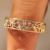 Cherry blossom flower wedding band with openwork design.
