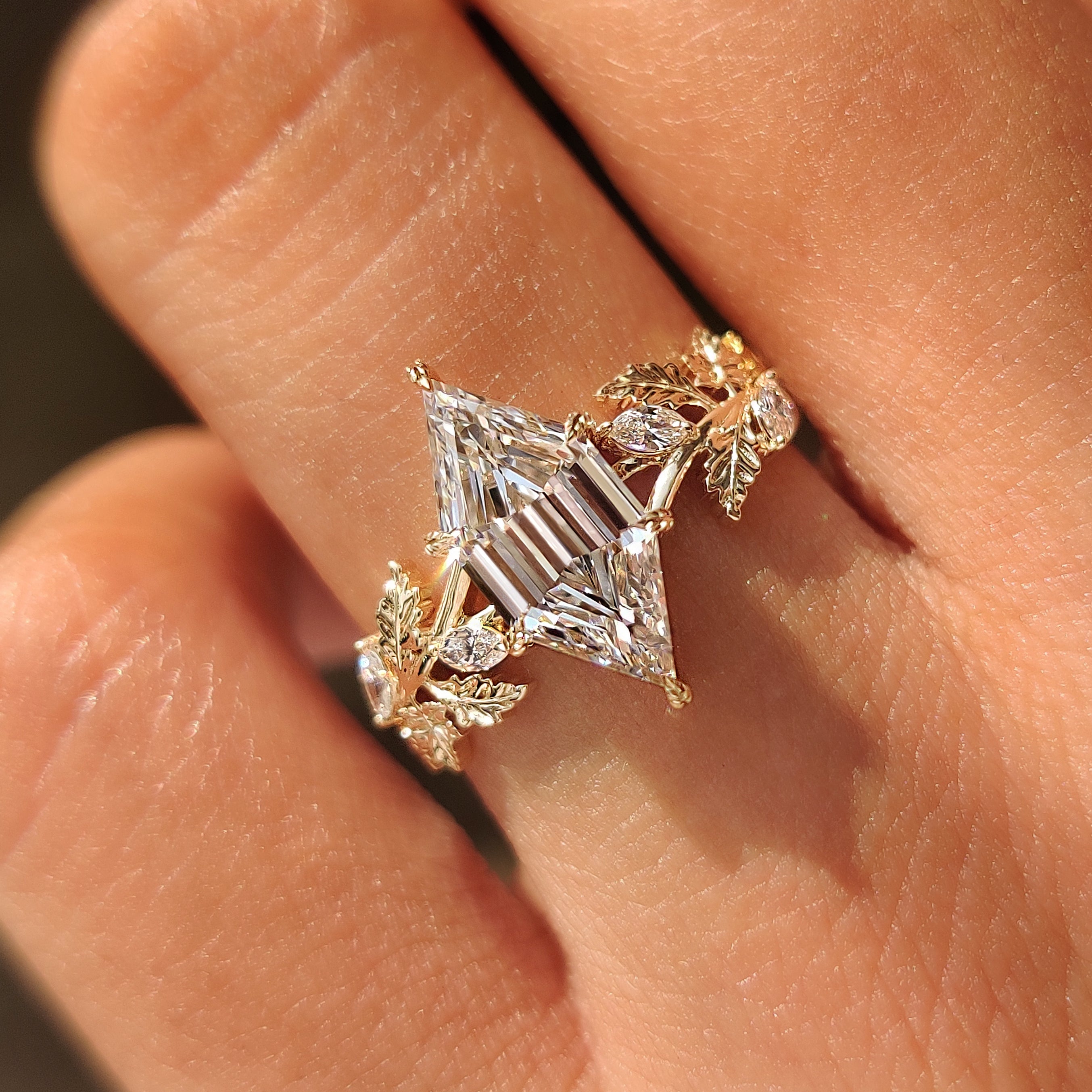 Yellow gold engagement ring with handcrafted autumn leaf details.
