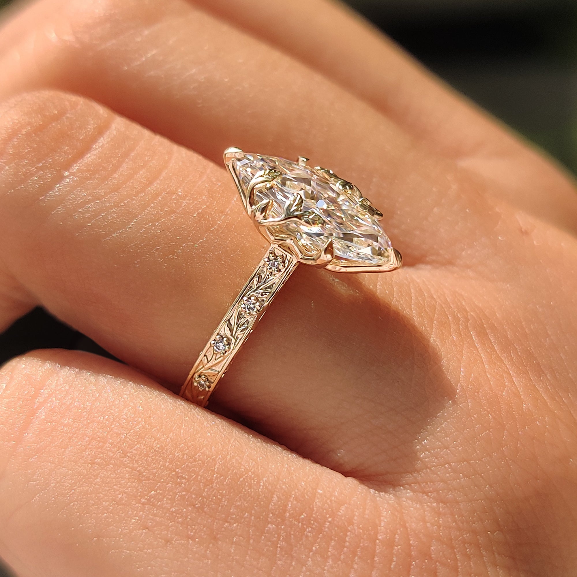 Marquise cut engagement ring with tulip setting .
