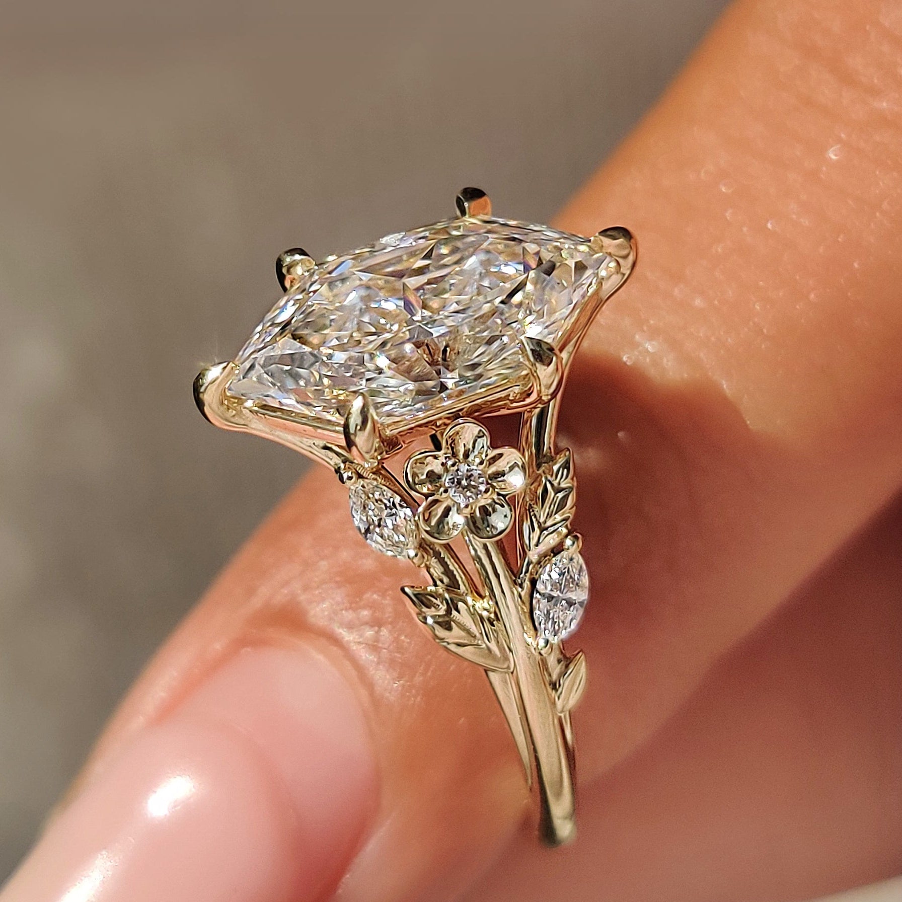 Leaf vine and flower design on a nature inspired engagement ring.
