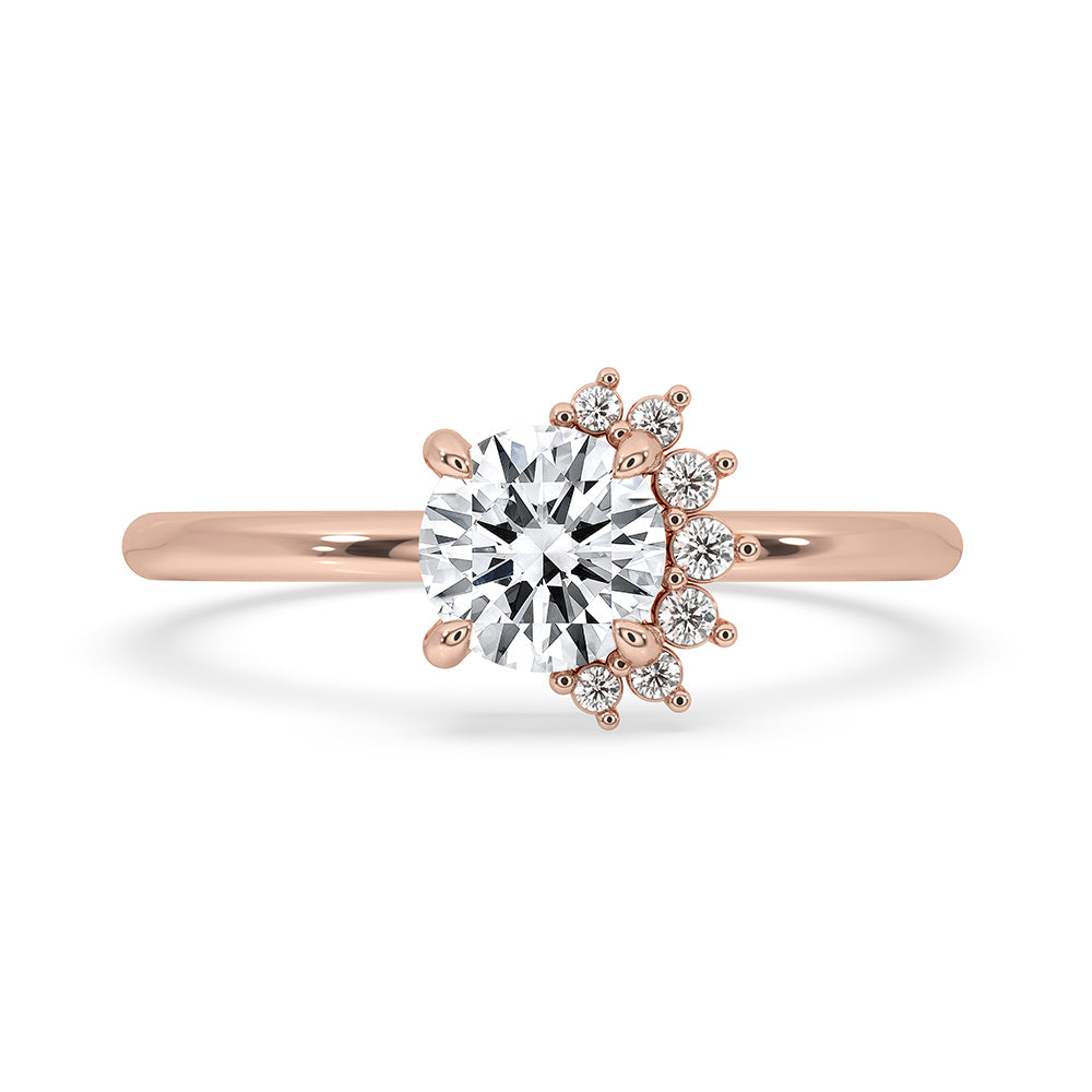 Half Halo Engagement Ring with a round cut diamond in a prong setting, designed in rose gold.
