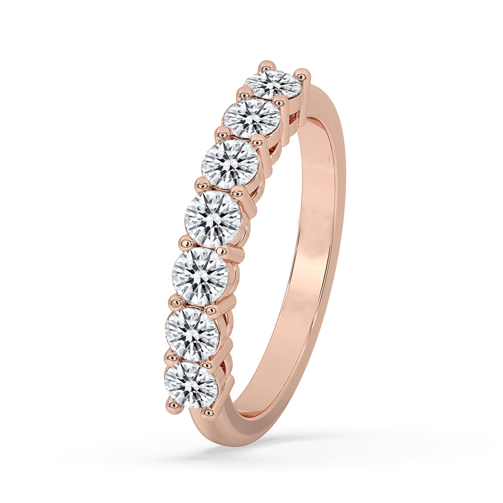 Round cut diamond band featured in rose gold band with handmade band details.
