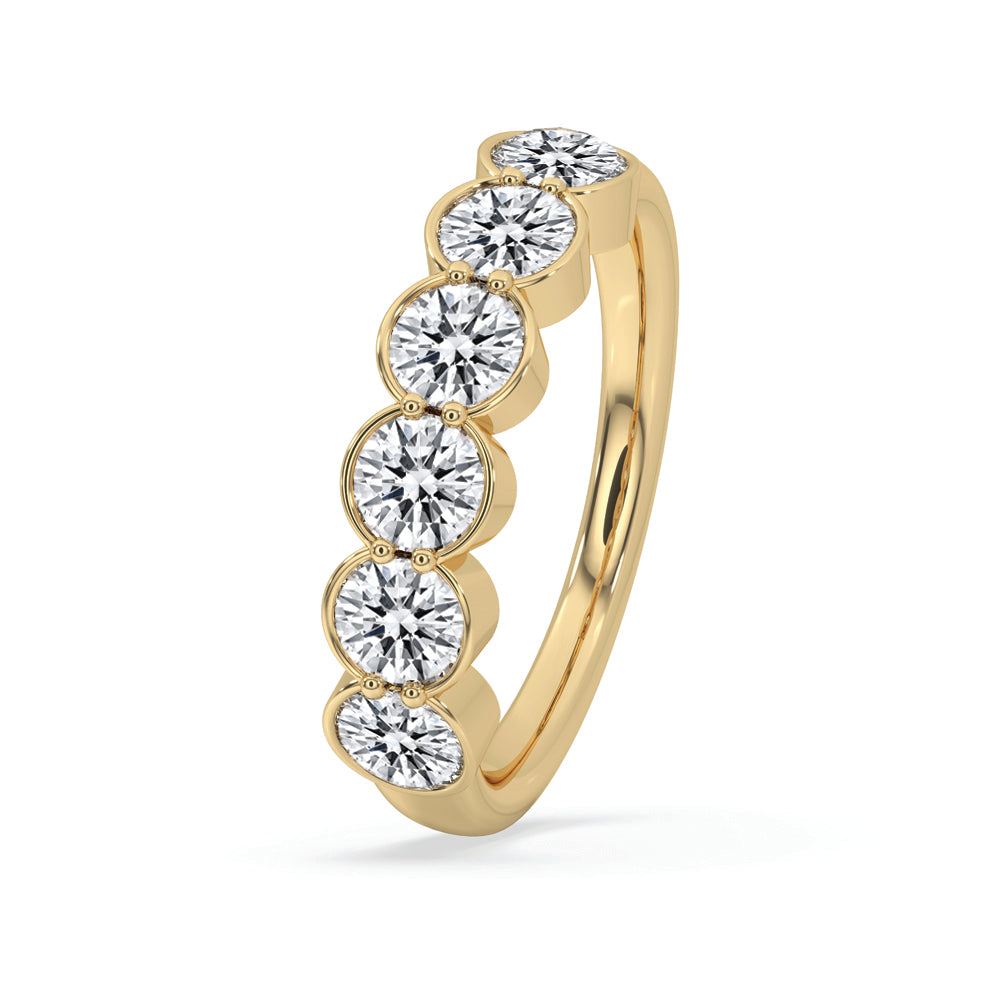 Half eternity band featuring bezel set diamonds in a custom wedding band design.
