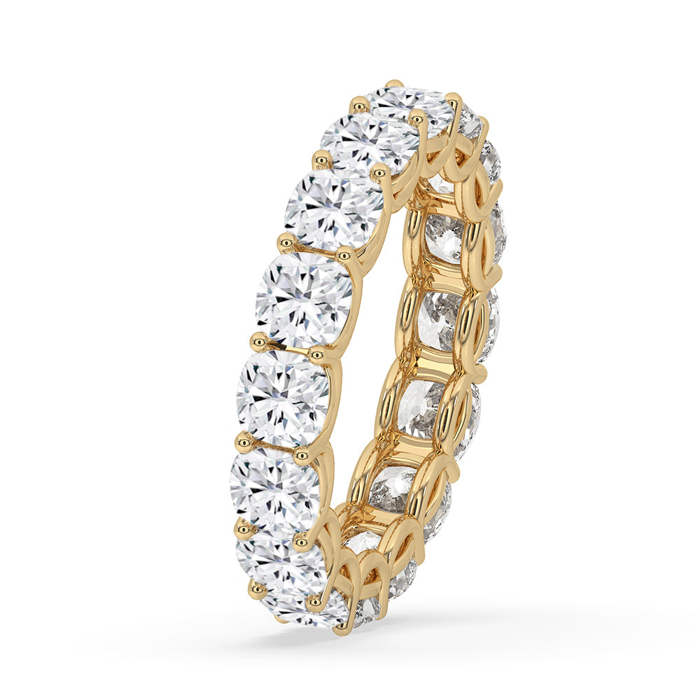Yellow gold band with cushion cut diamonds in a prong set style.
