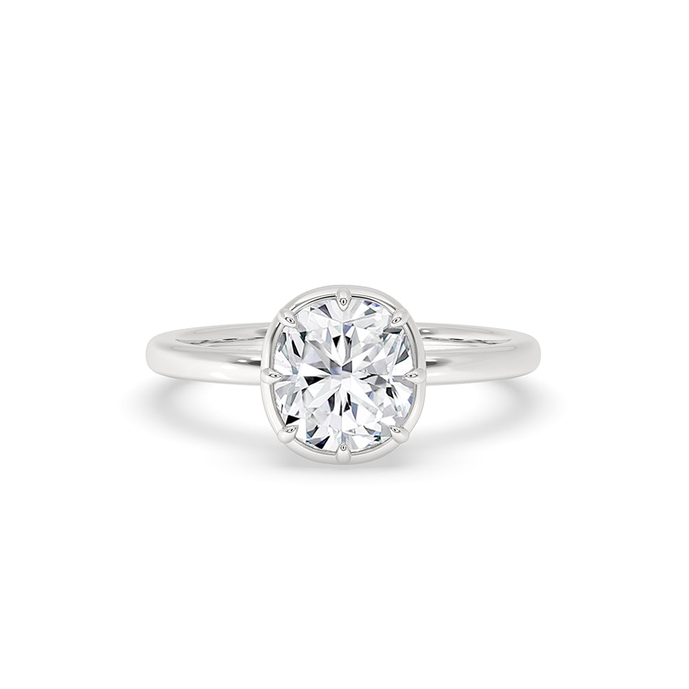 Bezel set diamond ring in white gold with cushion cut diamond design.
