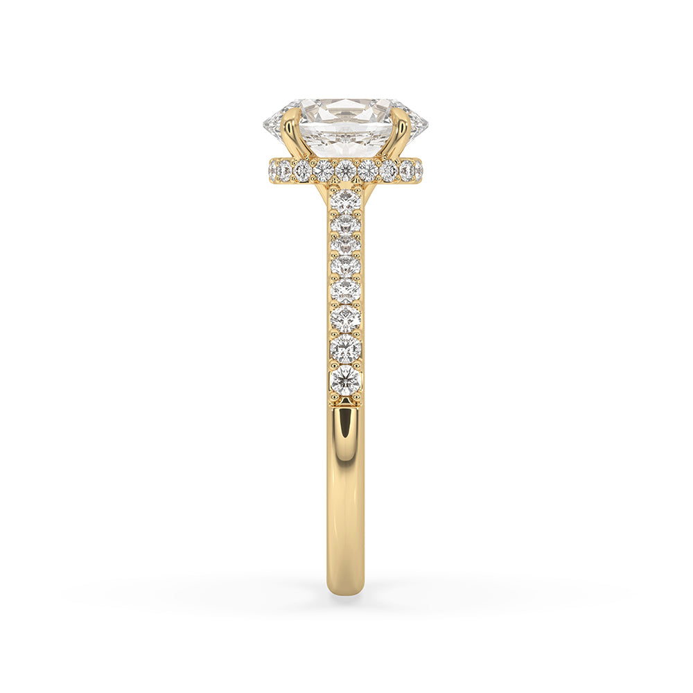 Handmade ring featuring a round cut diamond and pave setting.
