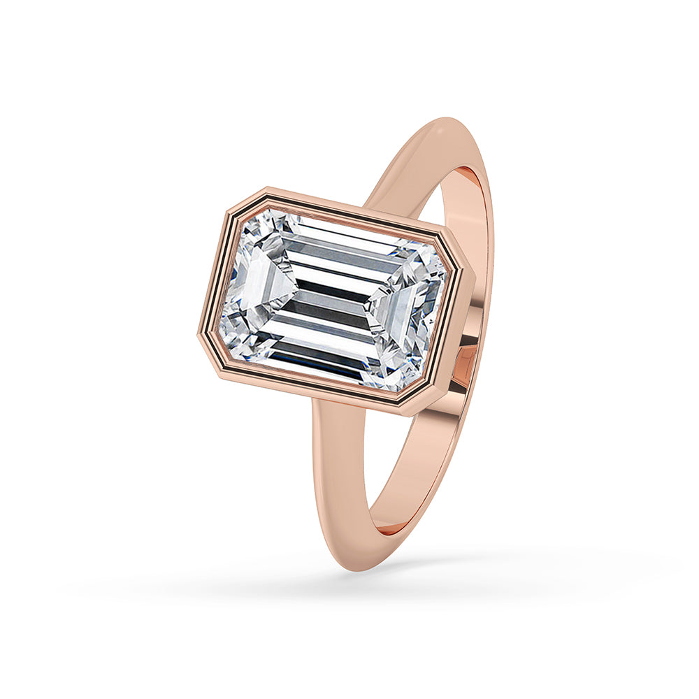 Emerald cut diamond ring with bezel setting.
