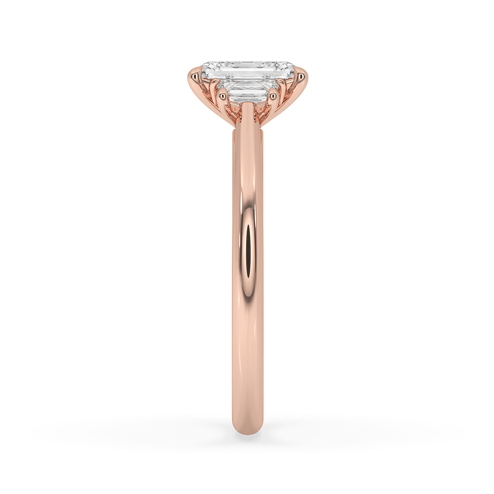 Handmade rose gold engagement ring with 3 stone emerald cut diamonds.
