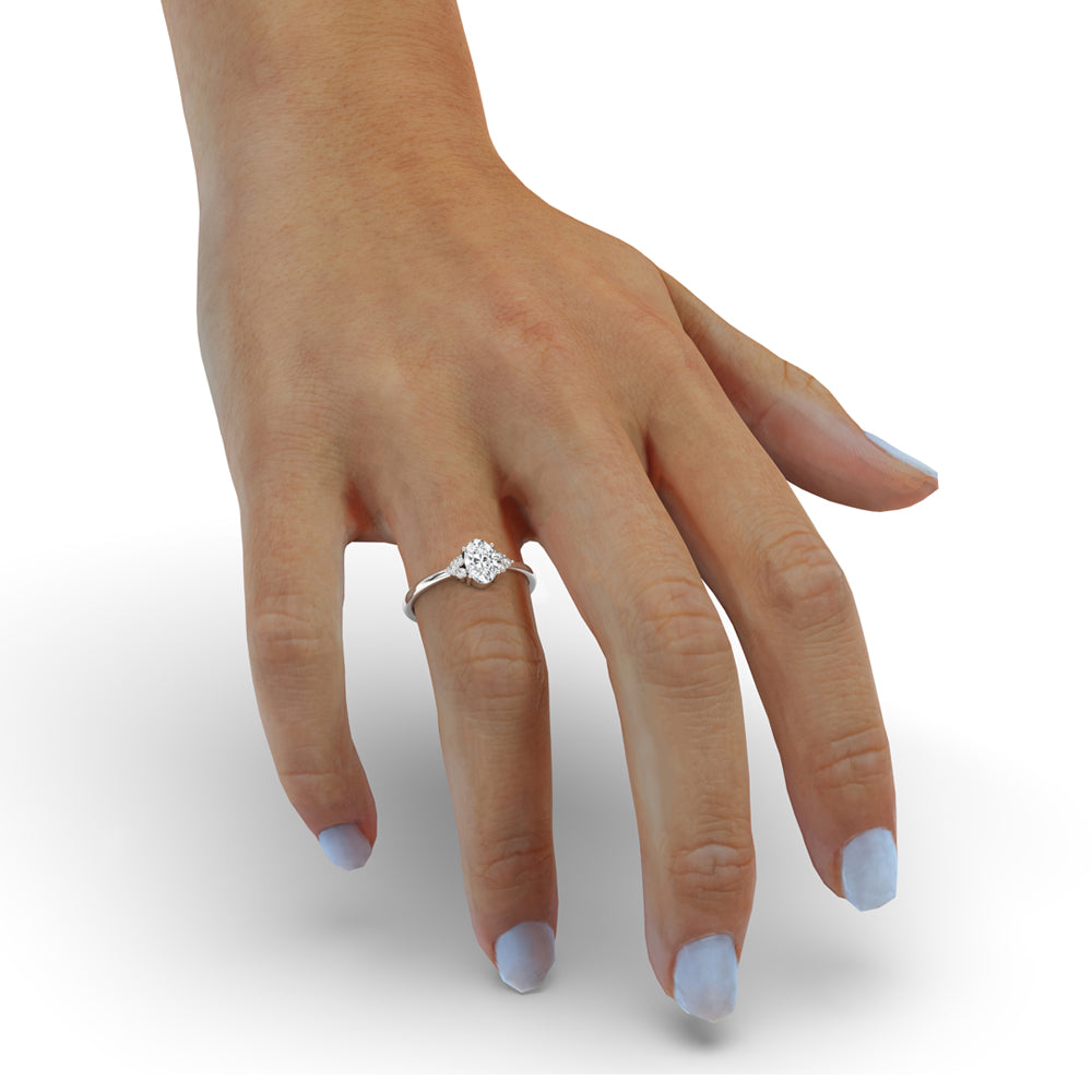 Oval cut diamond engagement ring featuring sidestones, IGI certified and crafted as a handmade ring.
