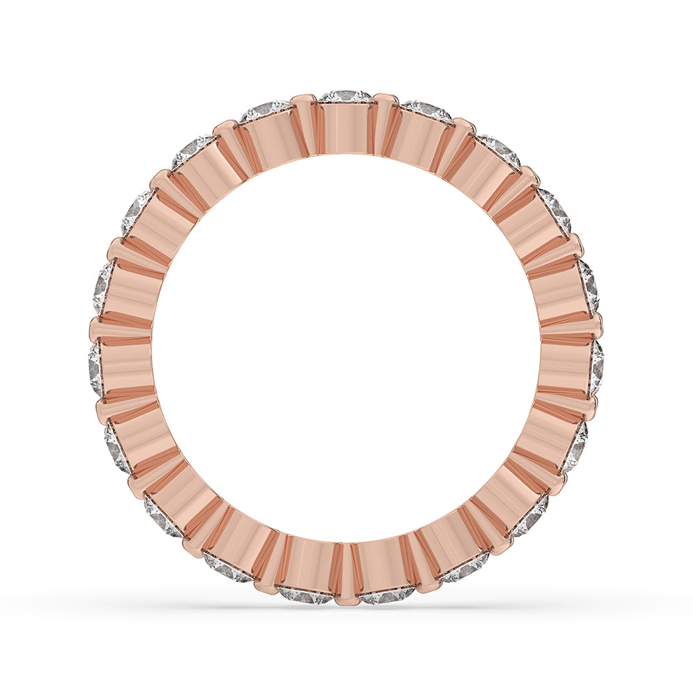 Shared prong wedding band with round cut diamonds in rose gold.
