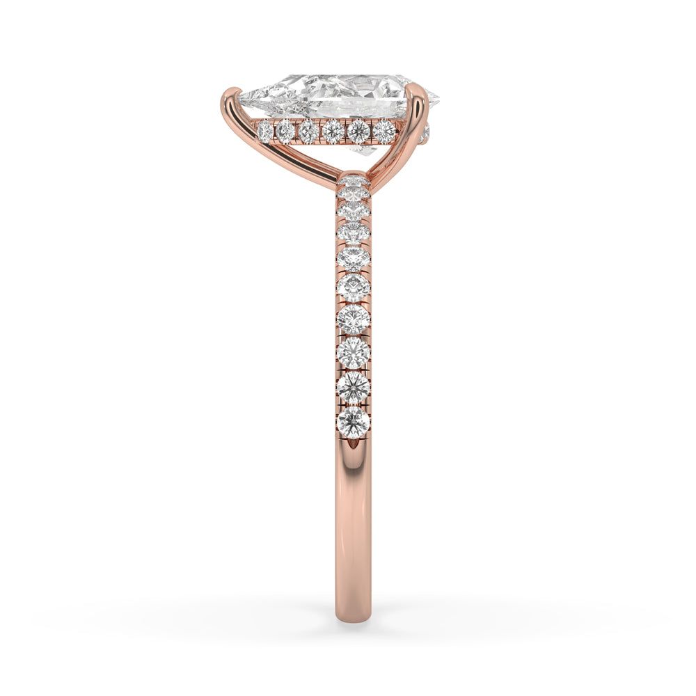 Handmade pear engagement ring with claw setting and pave ring setting.