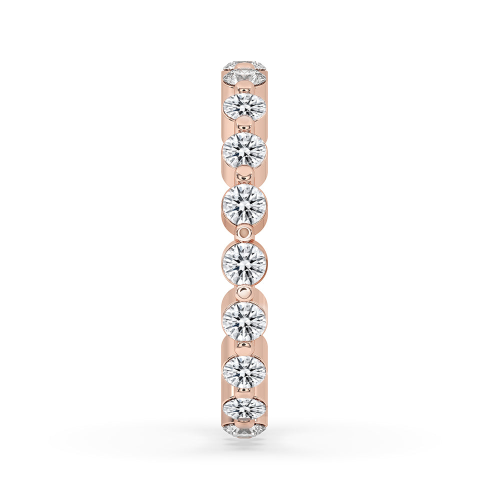 Round cut wedding band in rose gold with full eternity design.
