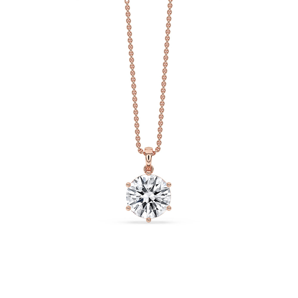 Rose gold pendant with round diamond center.
