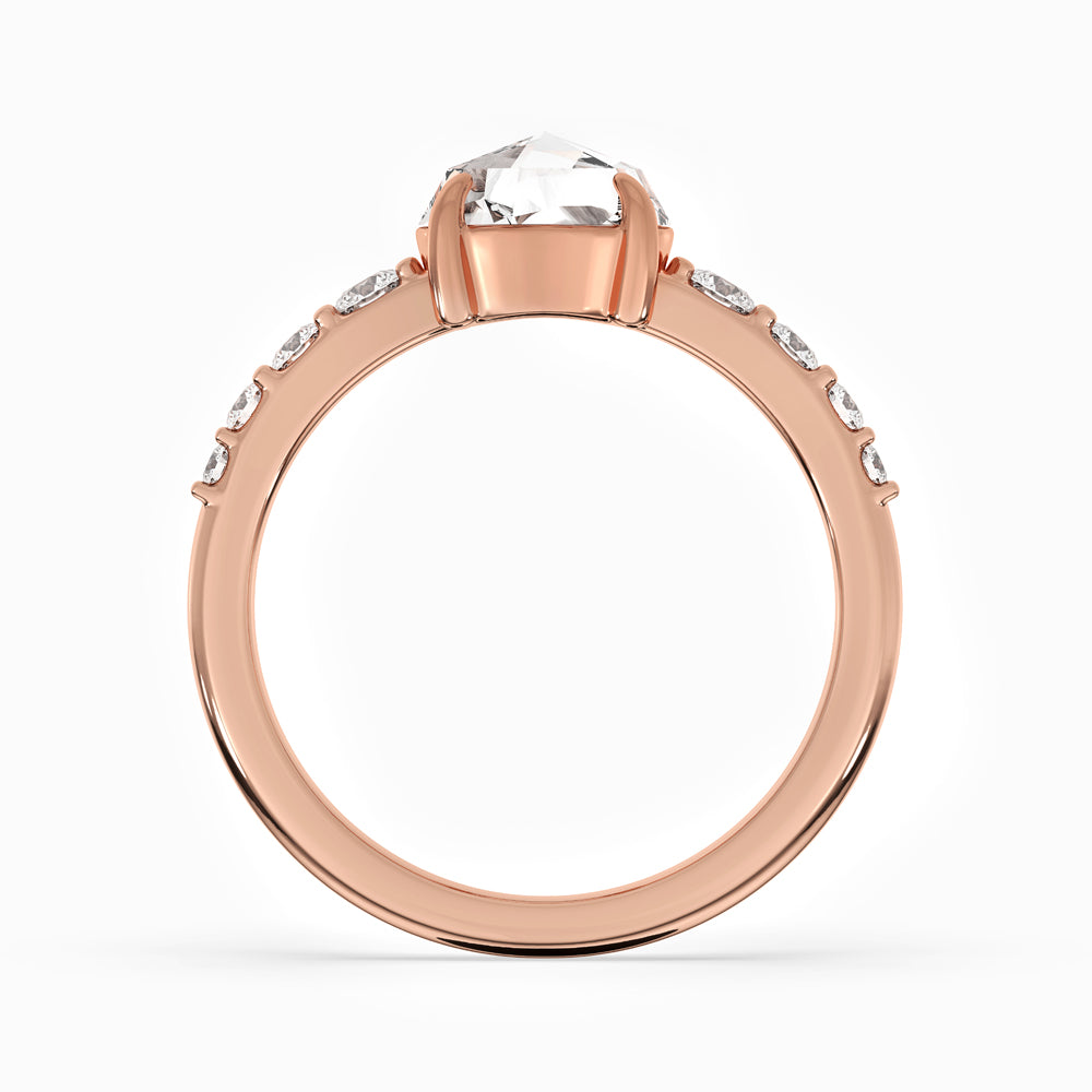 Custom engagement ring in rose gold featuring a tapered pave set band
