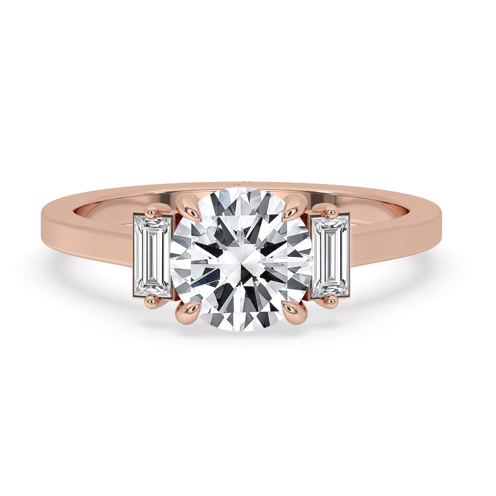 Three stone engagement ring with round diamond accents, set in a classic claw prong setting.
