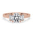 Three stone engagement ring with round diamond accents, set in a classic claw prong setting.
