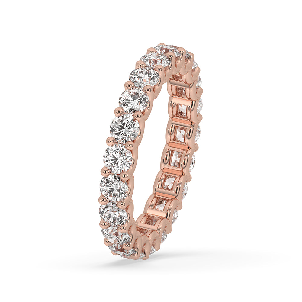Eternity wedding band featuring round diamonds in a rose gold band.
