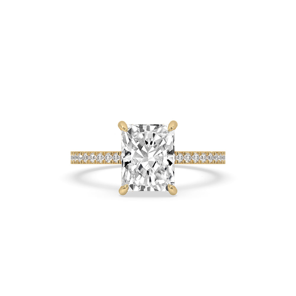 Radiant cut diamond ring displayed in natural light.