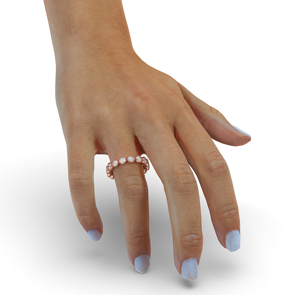 Bezel set wedding band featuring round diamonds for a chic look.
