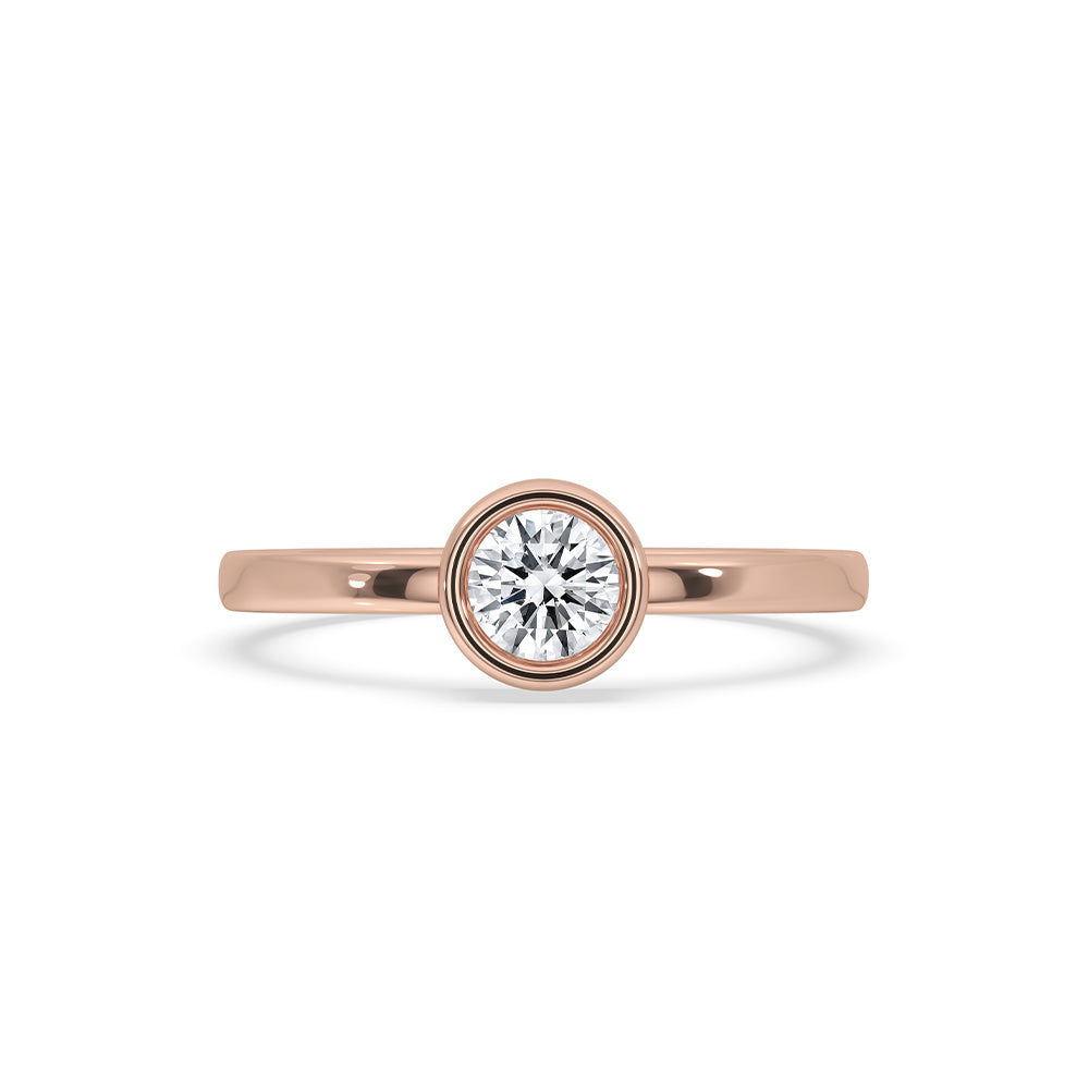 Bezel set round diamond ring displayed on a soft velvet pad.