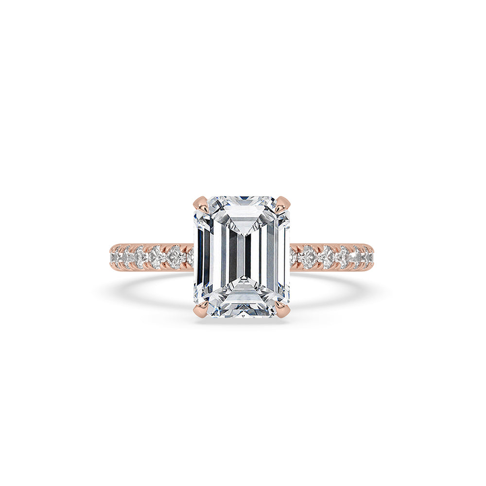 Rose gold emerald cut engagement ring with stunning pave diamonds.