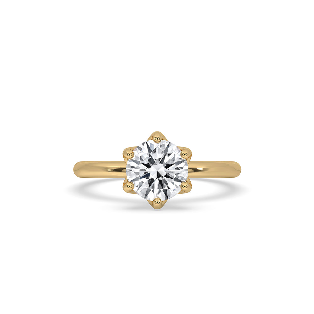 Gold solitaire engagement ring with a stunning diamond.
