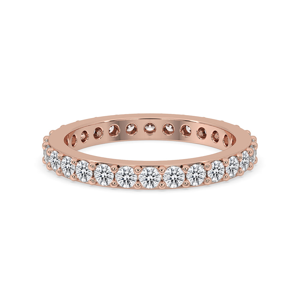 Round cut diamond band featuring a prong set design in rose gold.
