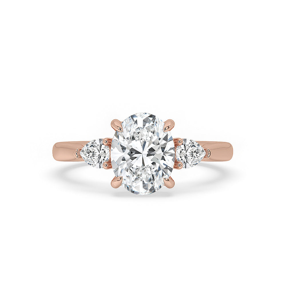 3 stone diamond ring with oval center and pear side stones.