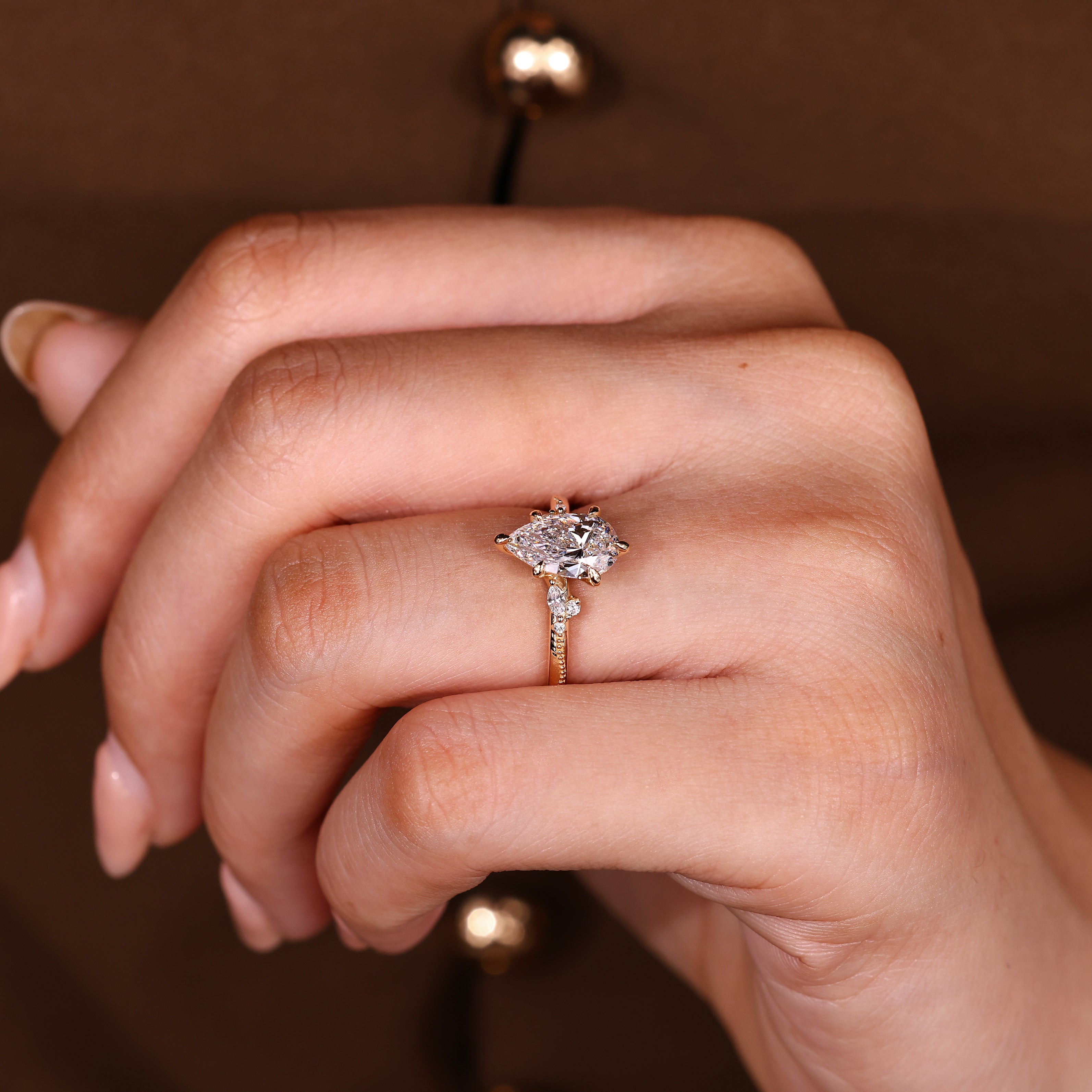 Pear engagement ring with six claw prong setting design

