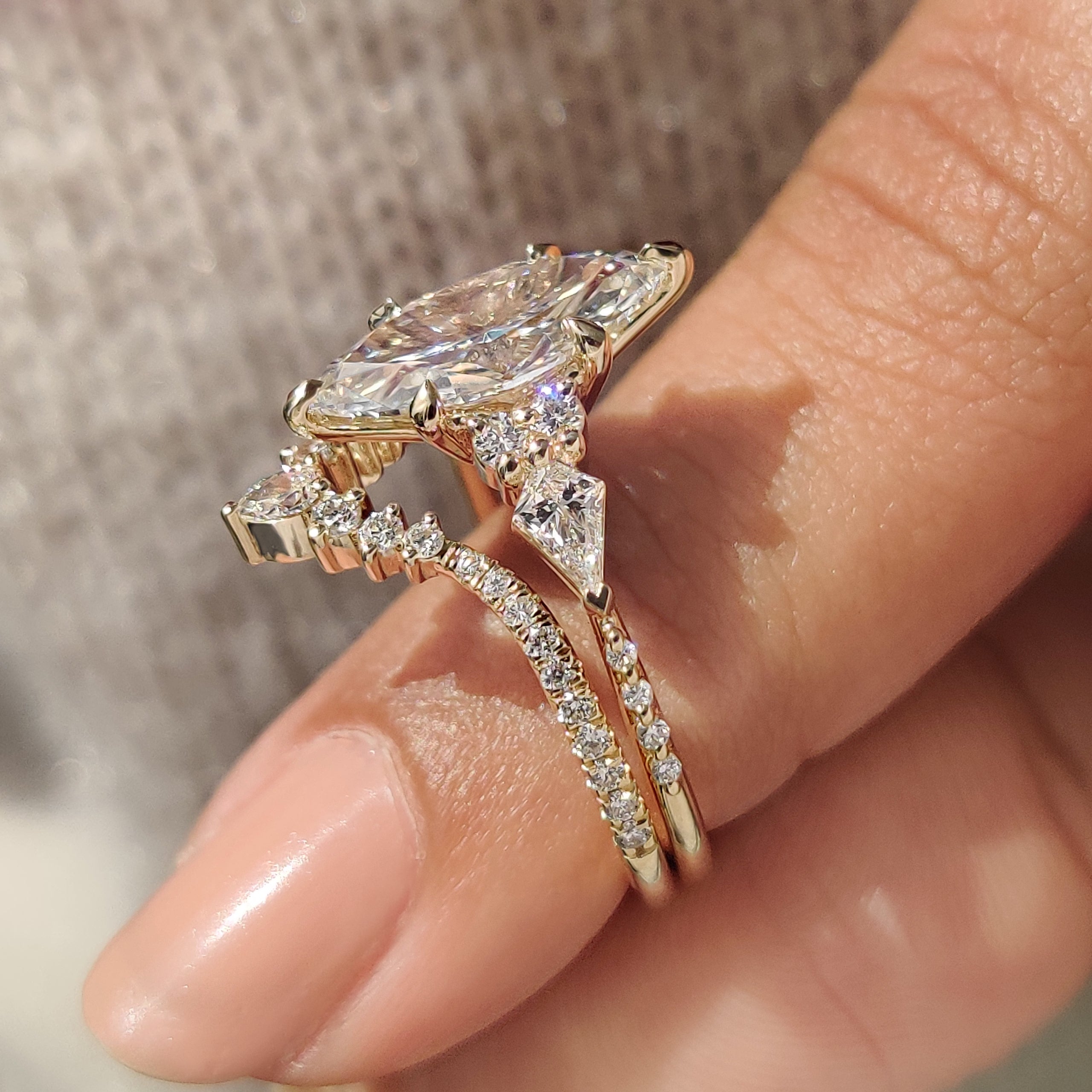 Handmade marquise engagement ring with tapered shank and band.
