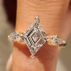 Lozenge cut engagement ring with kite side stones design
