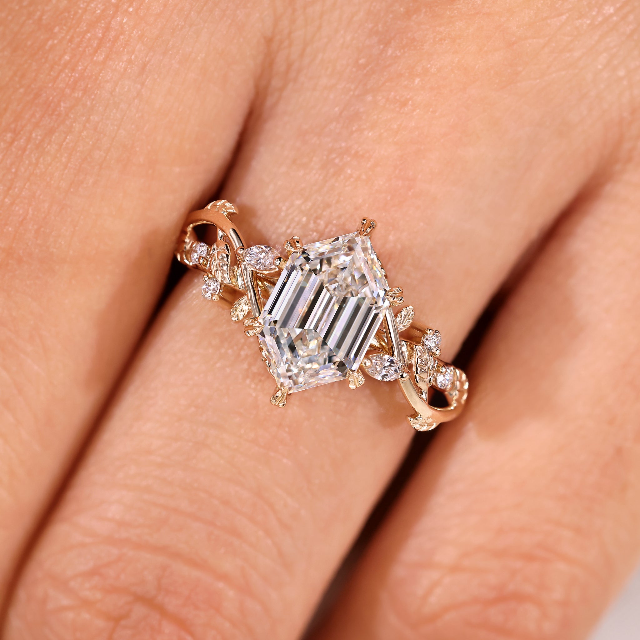 Hexagon step cut diamond ring with marquise and round side stones
