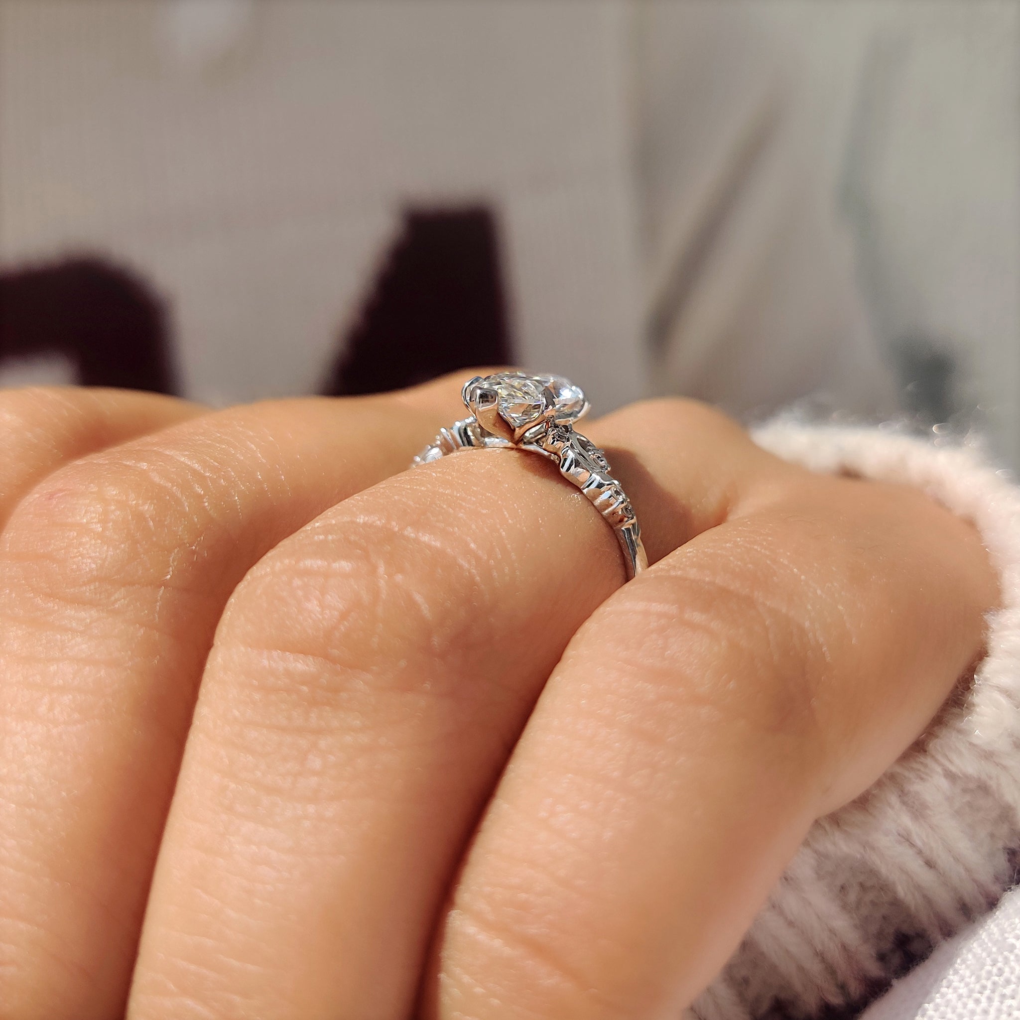 Marquise diamond ring with round side accents and prongs
