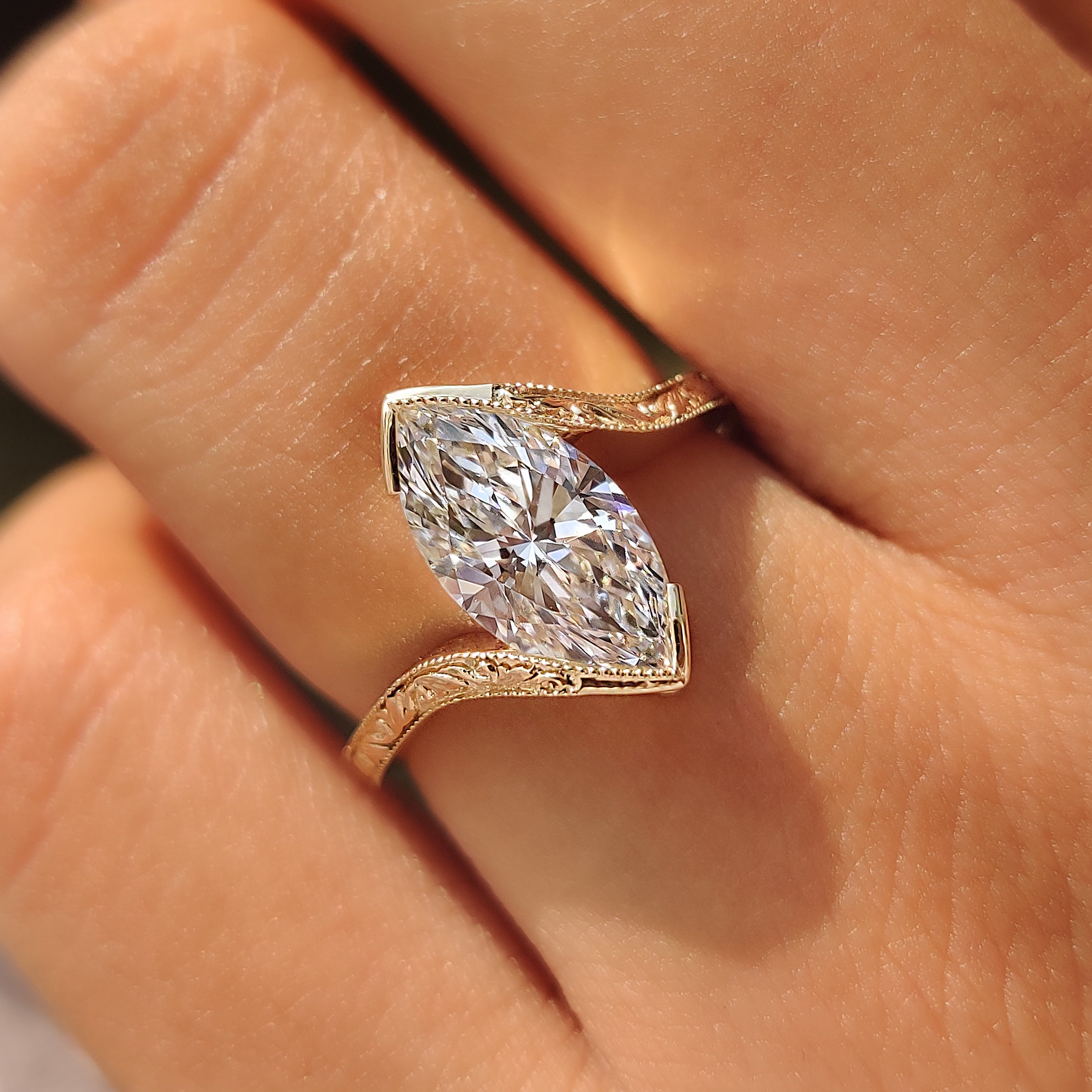 Milgrain detailing along a yellow gold marquise ring.
