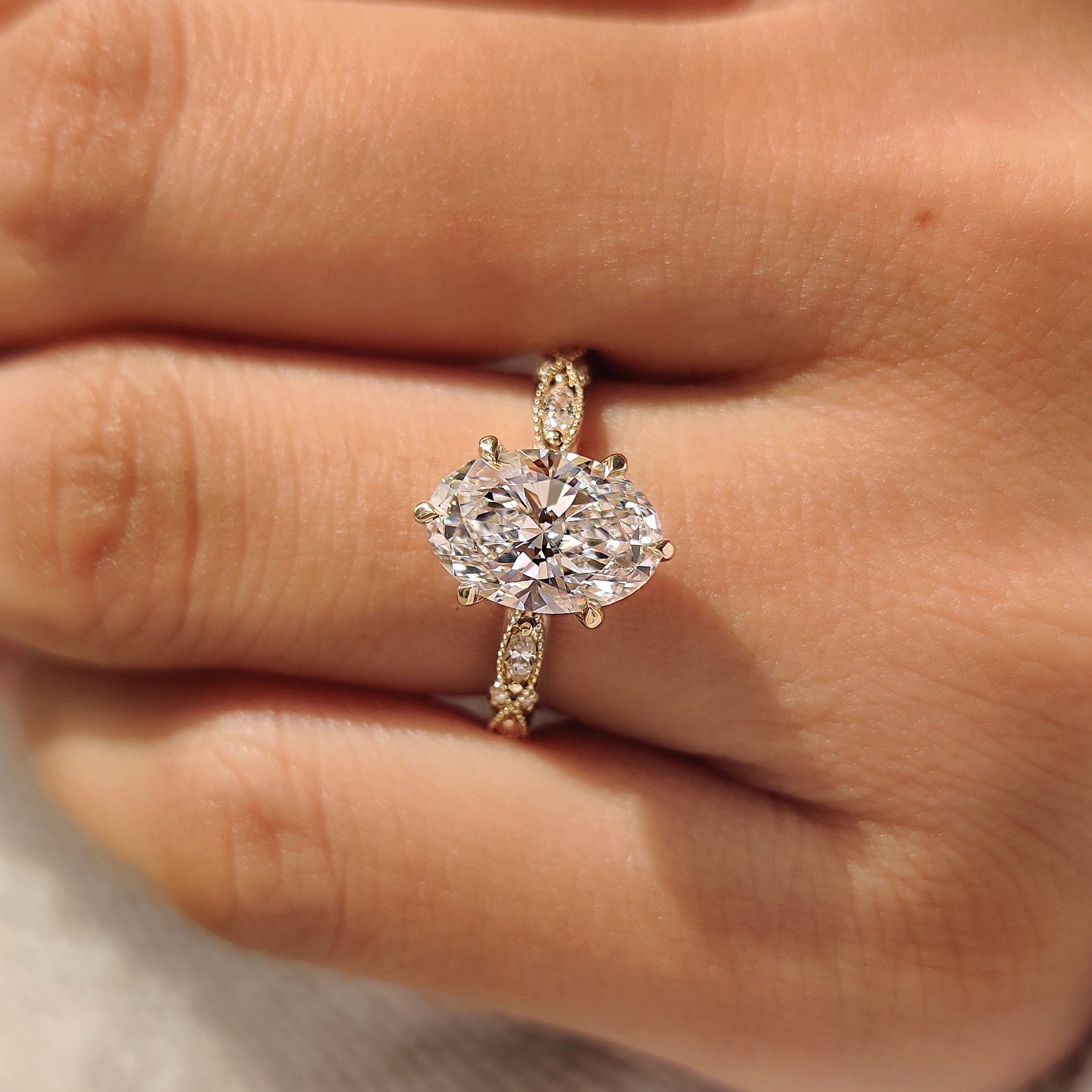 Handmade oval diamond ring with marquise and round stones
