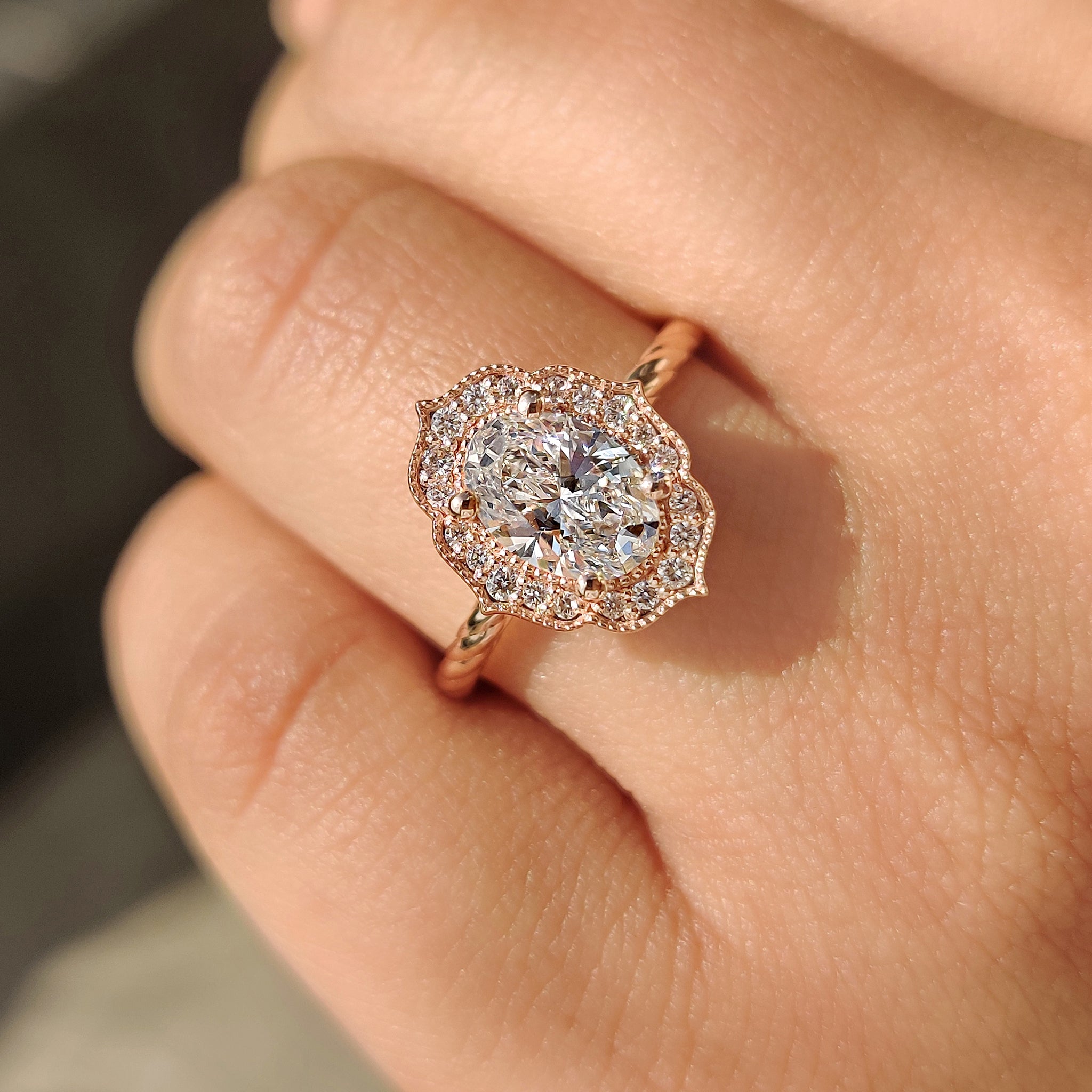 Lab grown oval diamond ring with milgrain detailing.
