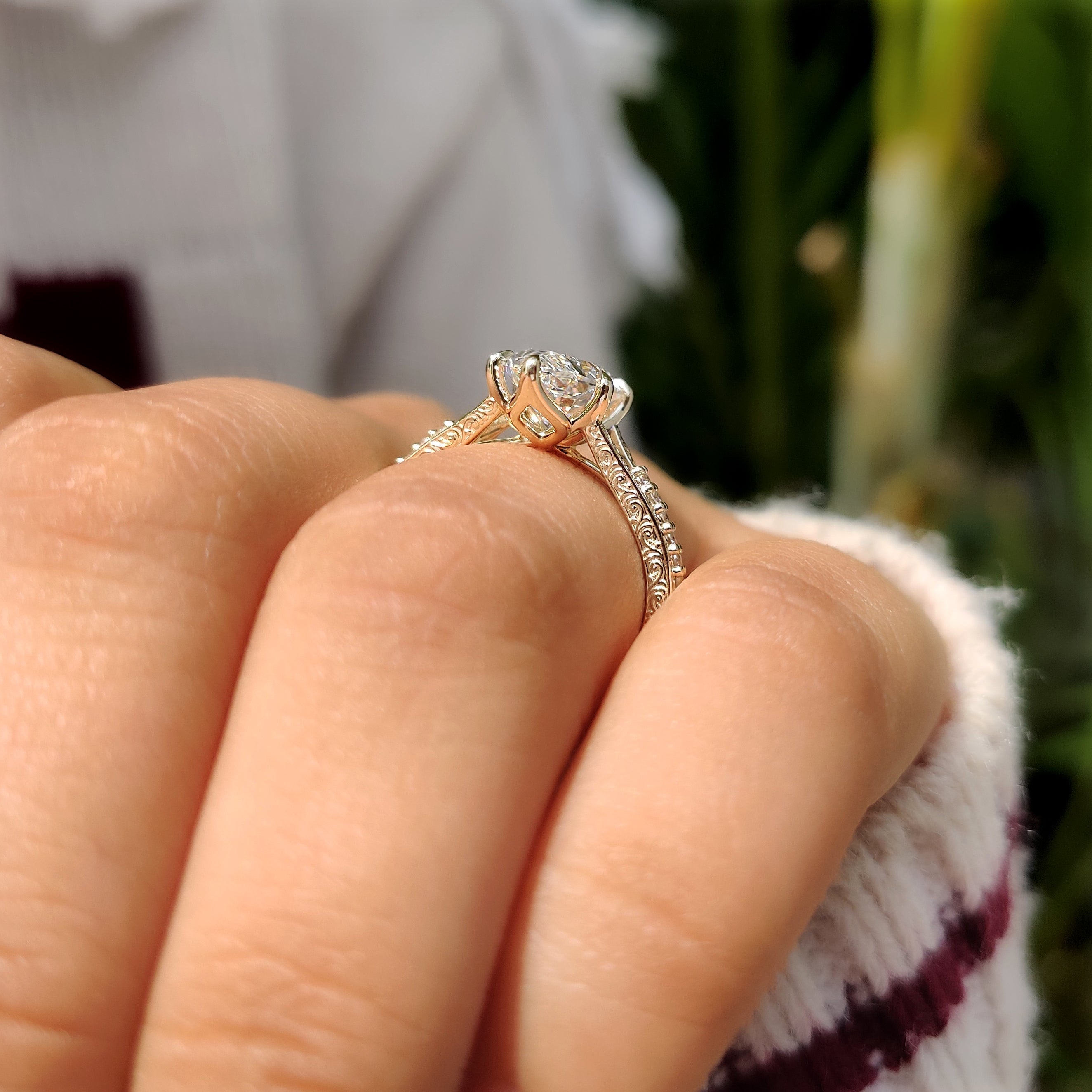 Marquise engagement ring with pave band and milgrain details
