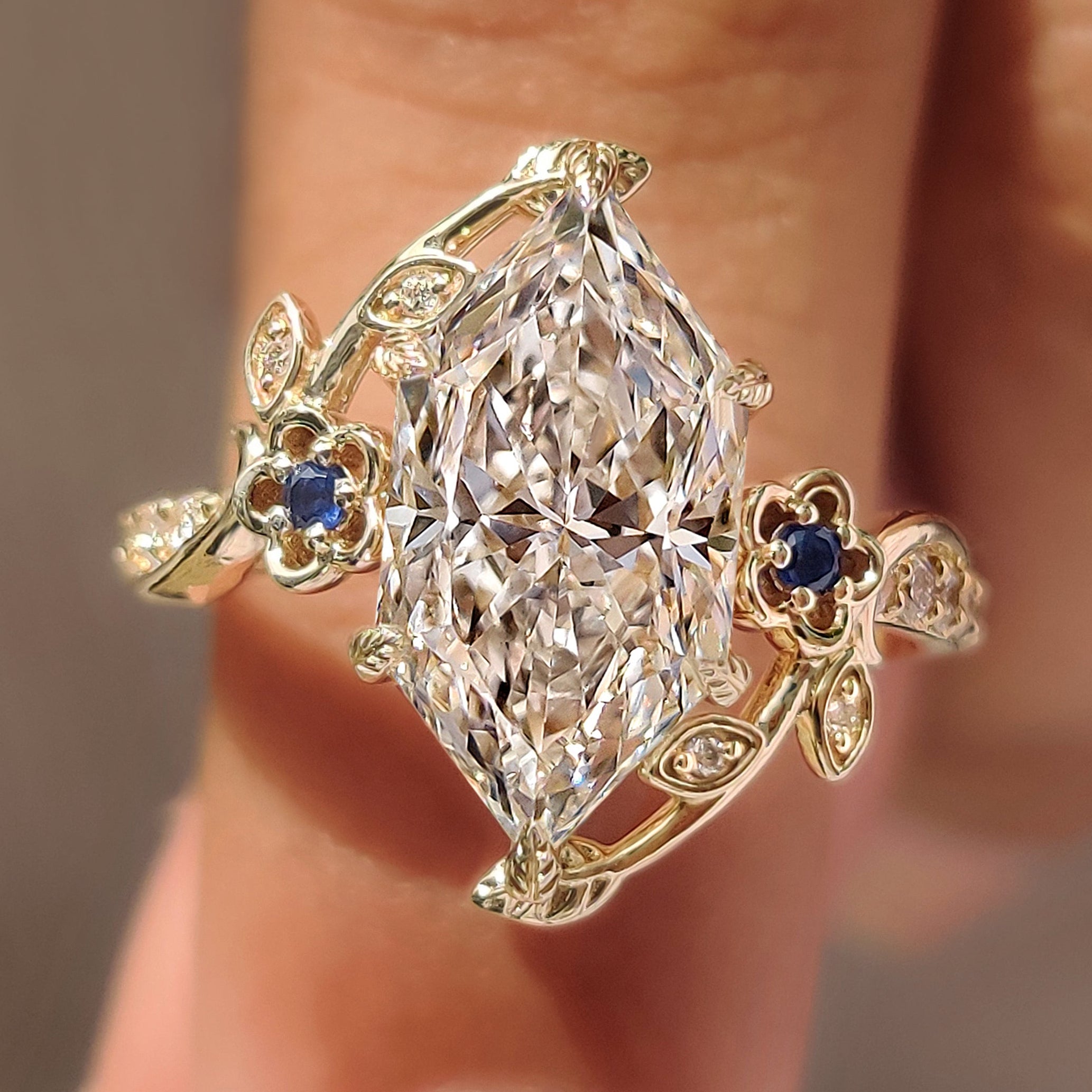 Dutch marquise ring with round blue sapphire side stones
