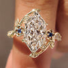 Dutch marquise ring with round blue sapphire side stones
