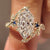 Dutch marquise ring with round blue sapphire side stones
