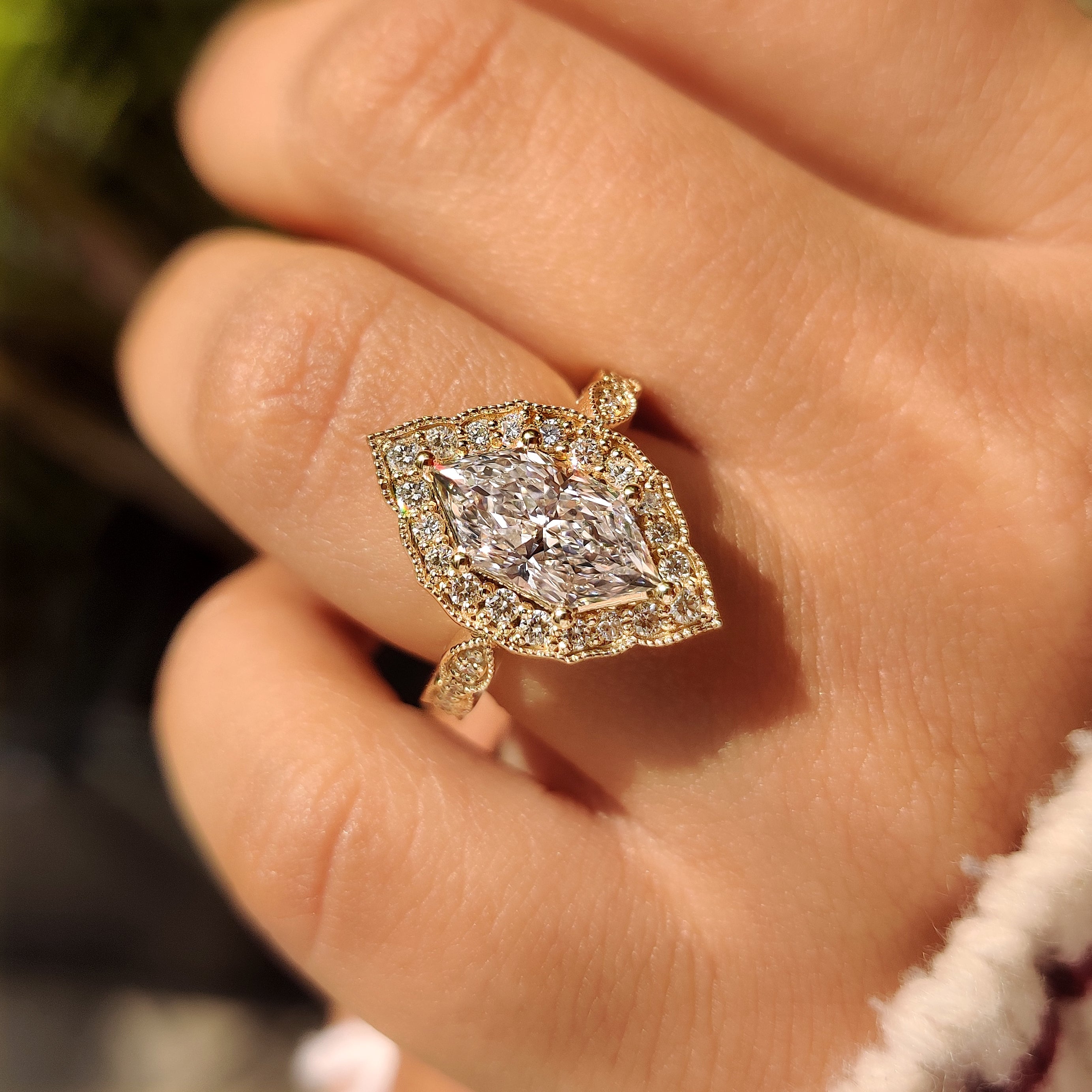 Dutch marquise diamond ring with four prongs and halo.
