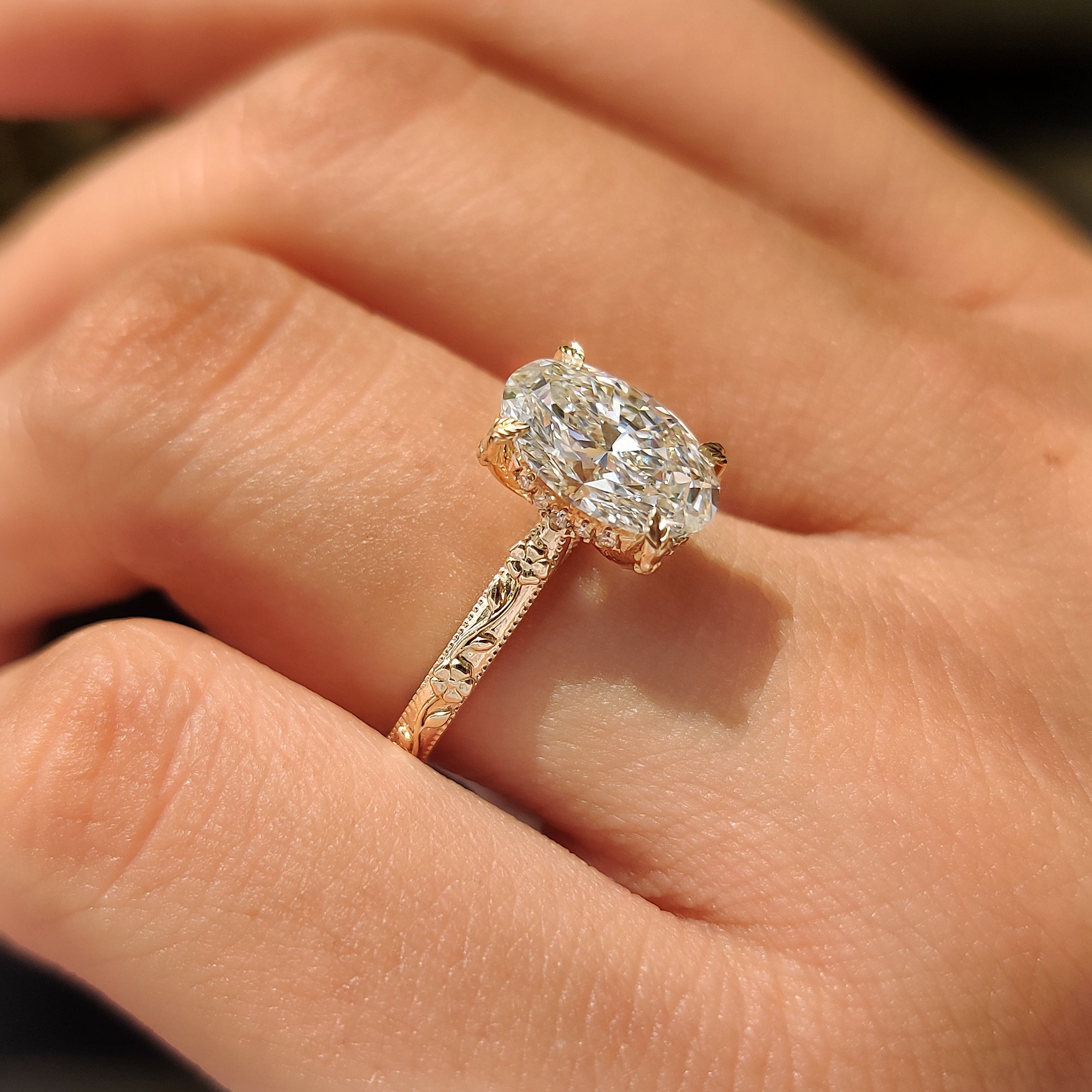Hand engraved floral shank design on solitaire ring.
