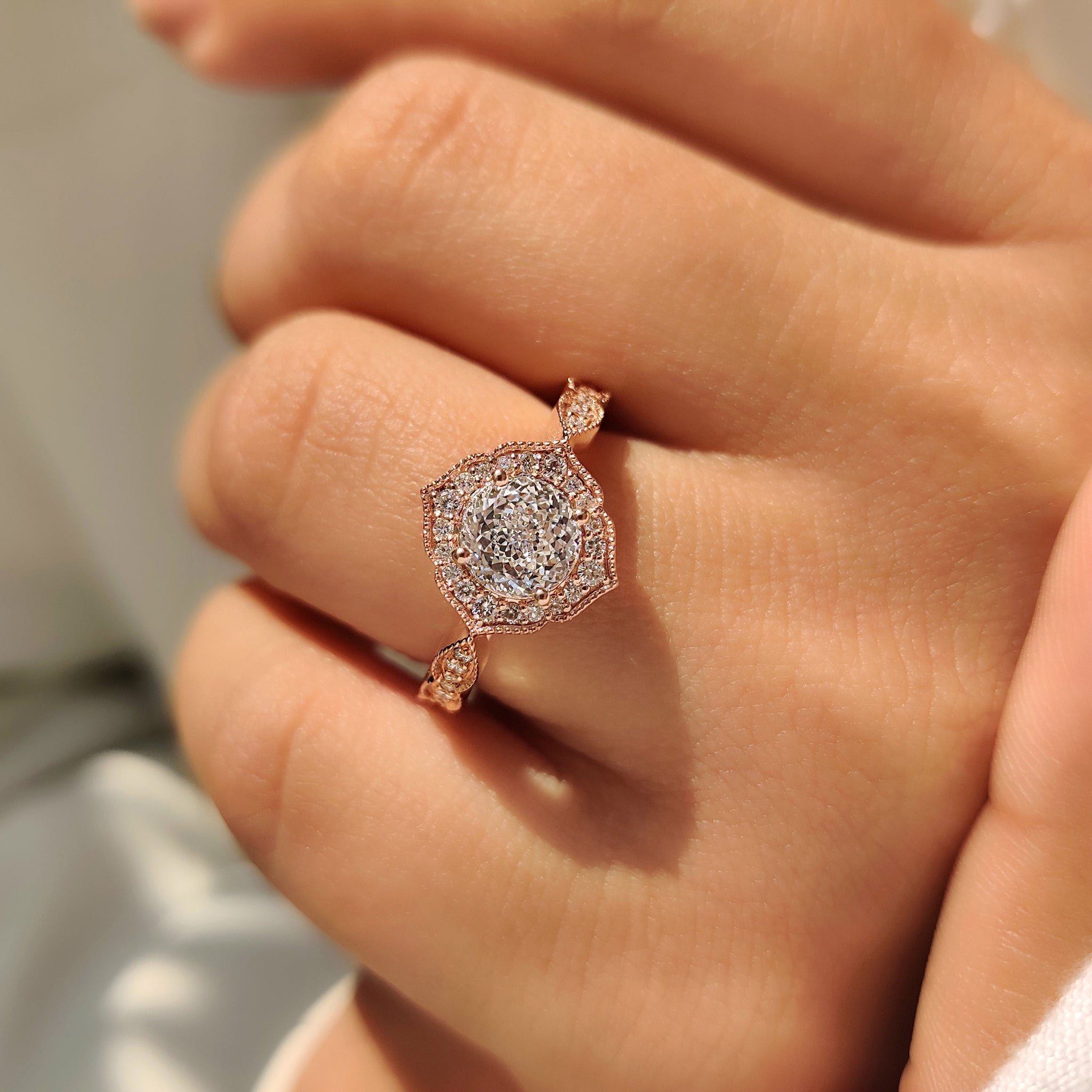 Portuguese cut diamond ring with round halo and pave band.
