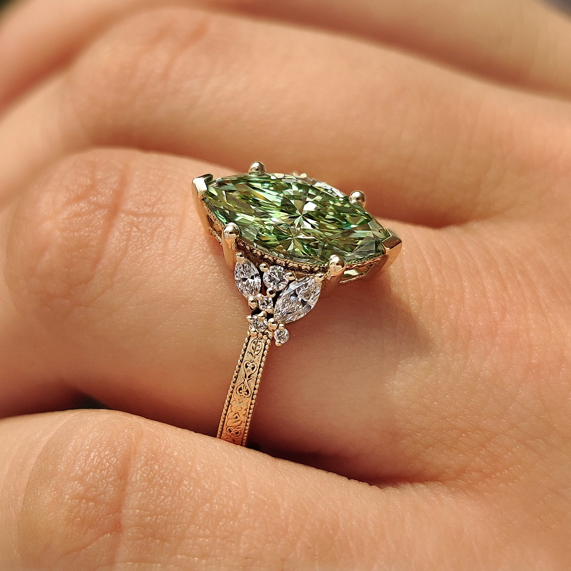 Marquise and round diamond cluster with floral details.
