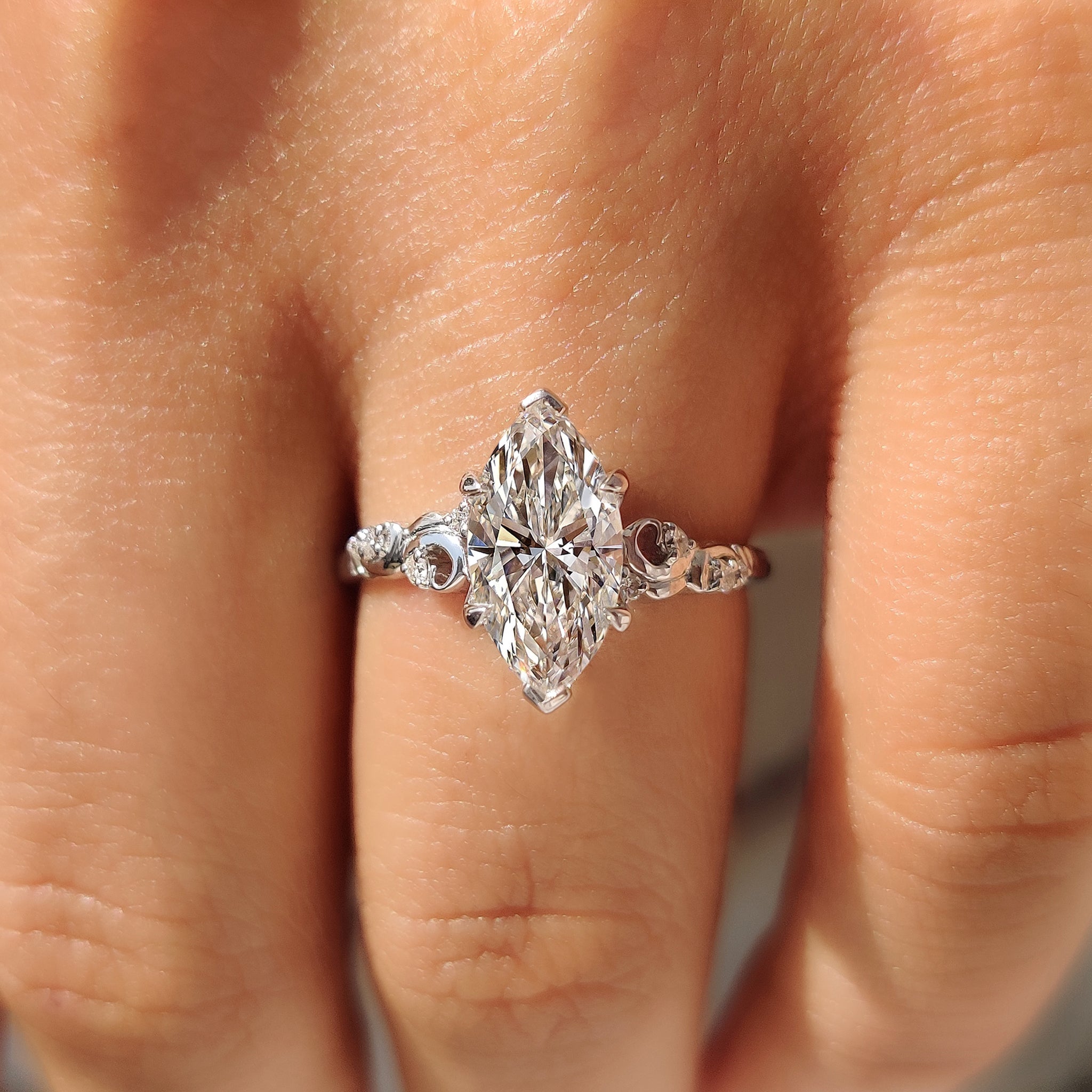 Handmade marquise diamond ring with round accent stones design
